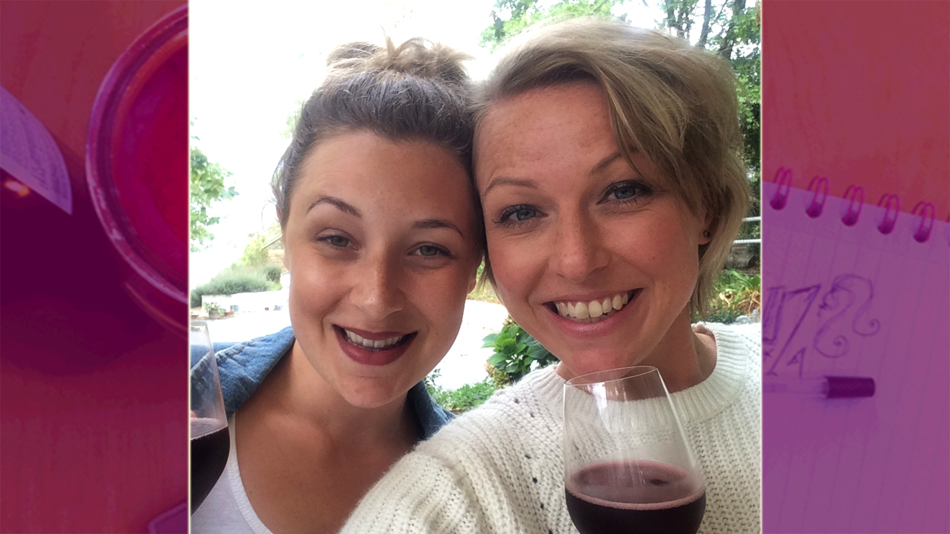 two women smiling with red wine