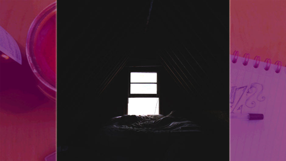 dark room in silhouette with bright white window