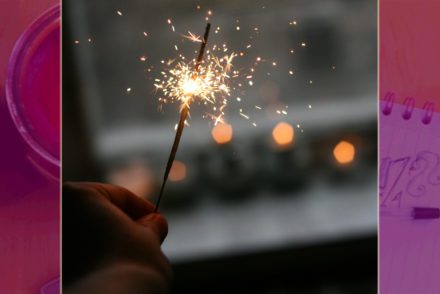 hand holding a sparkler at a window