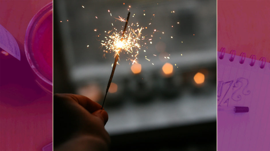 hand holding a sparkler at a window