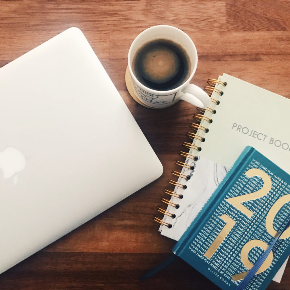 2019 notebook with a cup of coffee on a desk