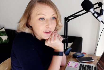 Jen Grieves sitting at a desk talking