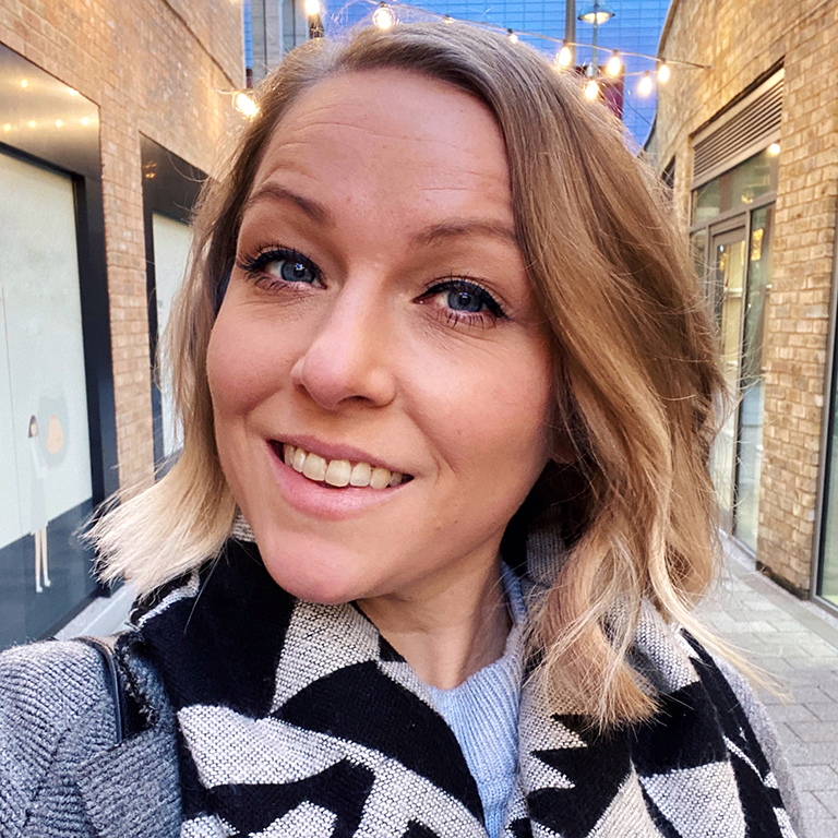 A selfie of a smiling Jen Grieves in North London wearing a scarf and winter coat